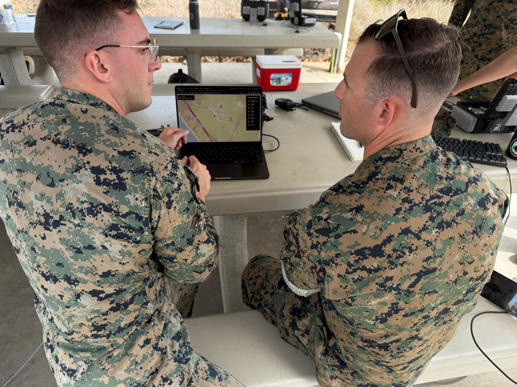 Patrick discussing AeroT feedback with a Marine in the field